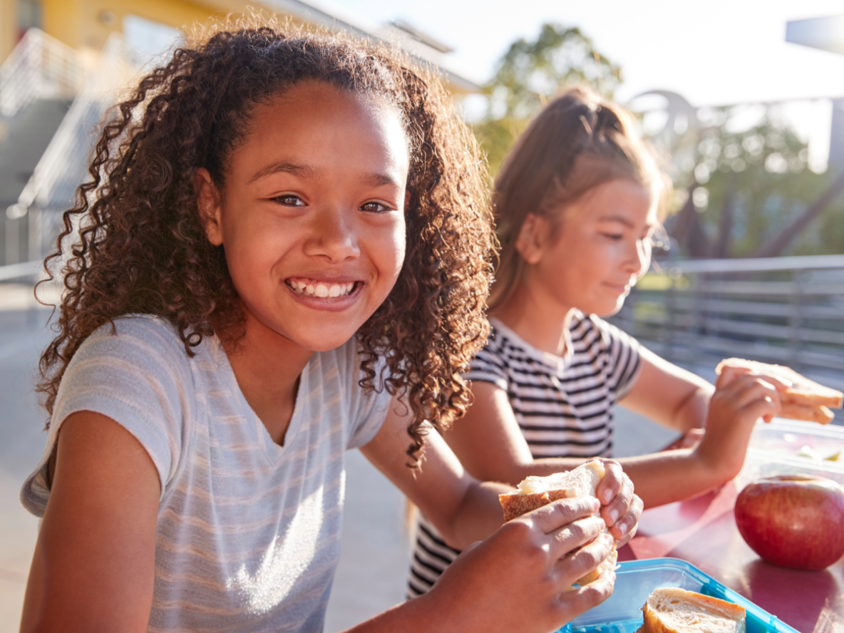 2 girls eating lunch outside
